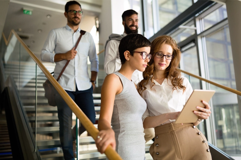 Group of professionals walking down stairs