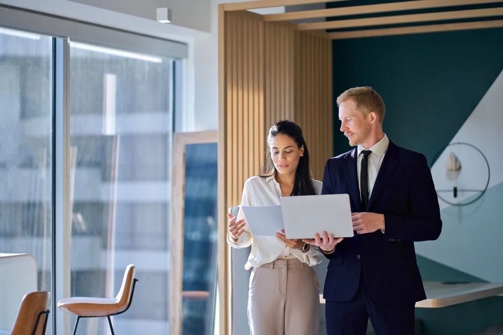 Two professionals looking at laptop