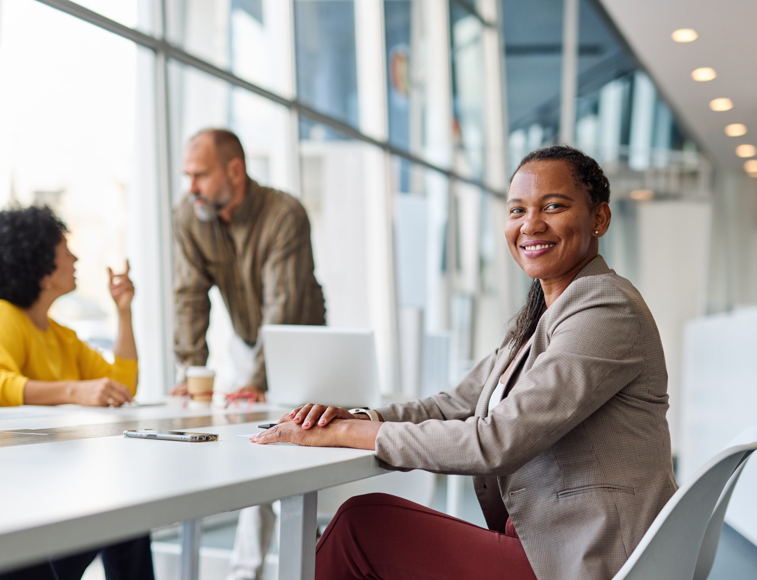 A professional new hire starts her career journey in a welcoming team setting.